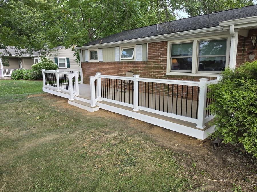 Completed low-level composite deck with white vinyl railing and black balusters, Richland PA — TrueCraft Decking